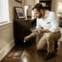 Agent inspecting air vent in apartment
