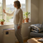 Woman airing out room by air purifier