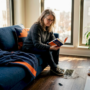 Woman relaxing near sunlit floor vent