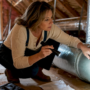 Homeowner inspecting HVAC duct blockage