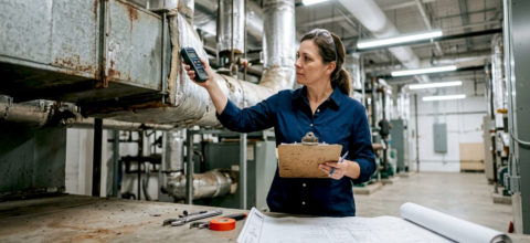 Facility manager inspecting HVAC ductwork