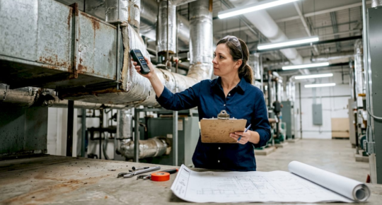 Facility manager inspecting HVAC ductwork