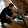 Inspector checking chimney with CO detector
