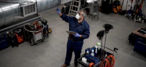 Janitorial trainer demonstrating vent cleaning