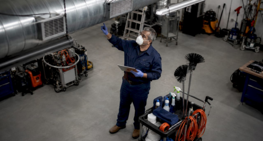 Janitorial trainer demonstrating vent cleaning