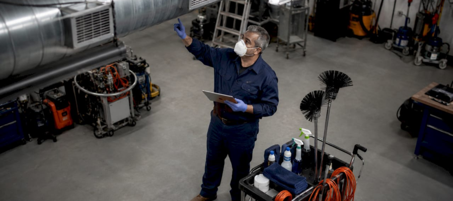 Janitorial trainer demonstrating vent cleaning