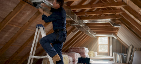 Technician installing home ventilation ducts