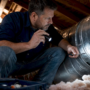 Homeowner inspecting HVAC air ducts