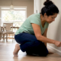Woman cleaning black soot from air conditioner vent