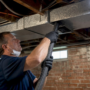Technician inspecting residential ductwork in attic