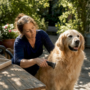 Woman grooming dog near floor vent
