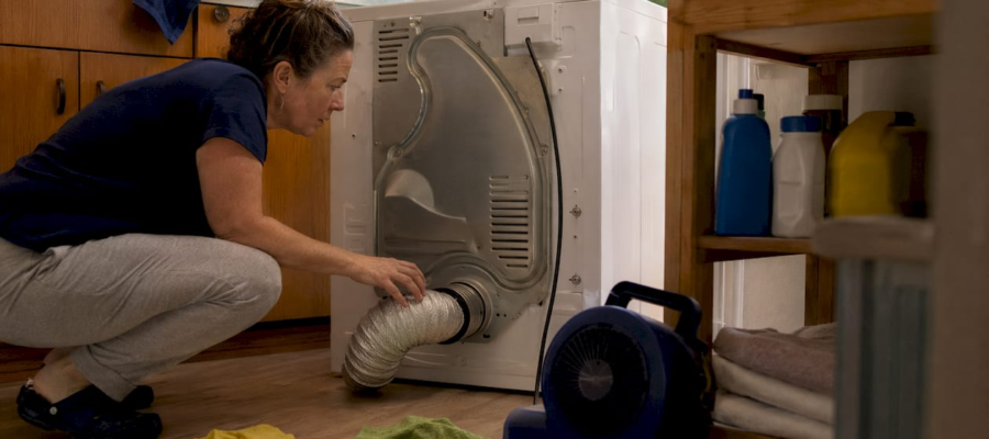 Homeowner inspecting dryer vent connection