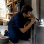 Technician inspecting residential air conditioning plenum