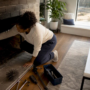 Homeowner inspecting fireplace interior