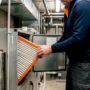 Technician replacing HVAC air filter