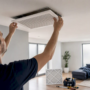 Hands removing vent cover during home renovation