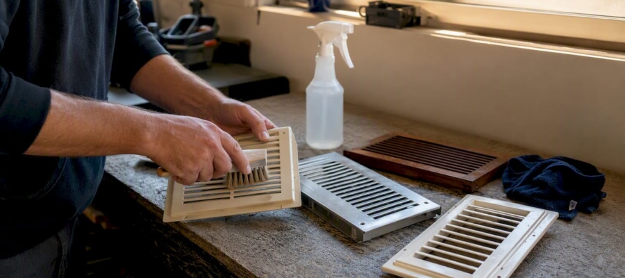 Hands cleaning plastic, metal, and wood vent covers