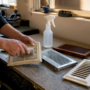 Hands cleaning plastic, metal, and wood vent covers