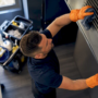 Hands wiping HVAC duct register cover