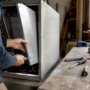 Technician removing air handler panel