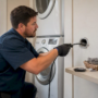 Hands cleaning condo dryer vent with rotary brush