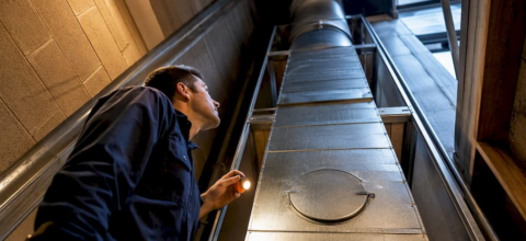 Technician inspecting multifamily dryer exhaust shaft