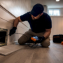 Technician guiding camera probe into air duct