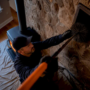 Professional cleaning a wood stove chimney flue