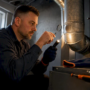 Technician inspecting a gas furnace flue