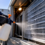 Technician disinfecting exposed HVAC coil fins