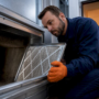 Technician inspecting hotel HVAC duct access