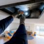Technician inspecting daycare classroom air duct