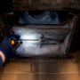 Hand inspecting fireplace damper plate