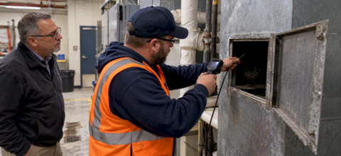 Technician verifying school duct condition