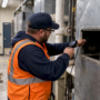 Technician verifying school duct condition