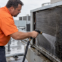 Technician rinsing a commercial HVAC coil