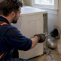 Technician cleaning a residential dryer vent