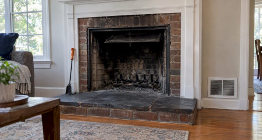 Soot-darkened summer fireplace with open damper