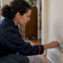 Owner inspecting mold on an apartment wall