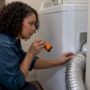 Property manager inspecting a dryer vent connection